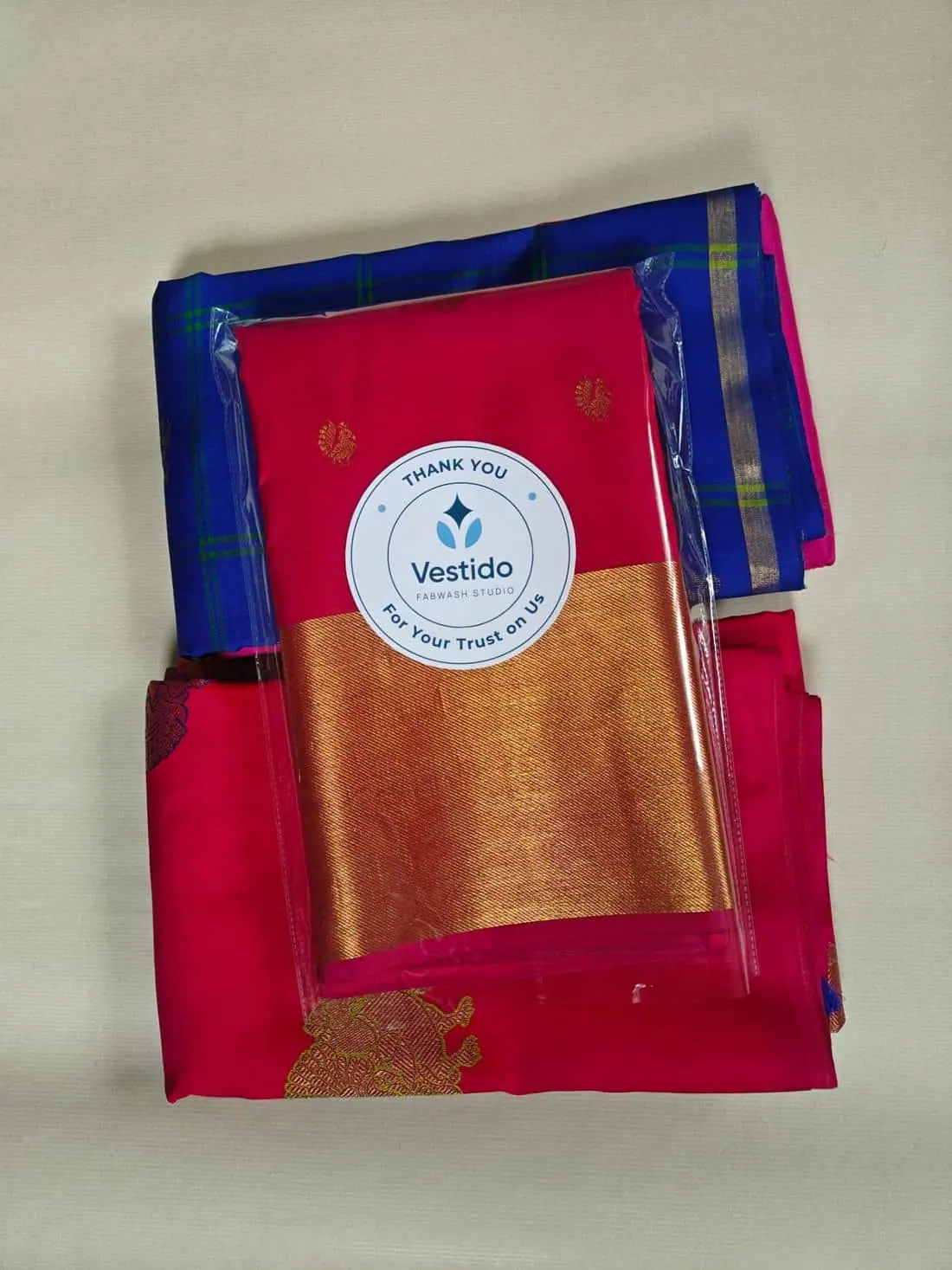 Red and blue silk sarees roll polished and finished at Vestido Fabwash Studio