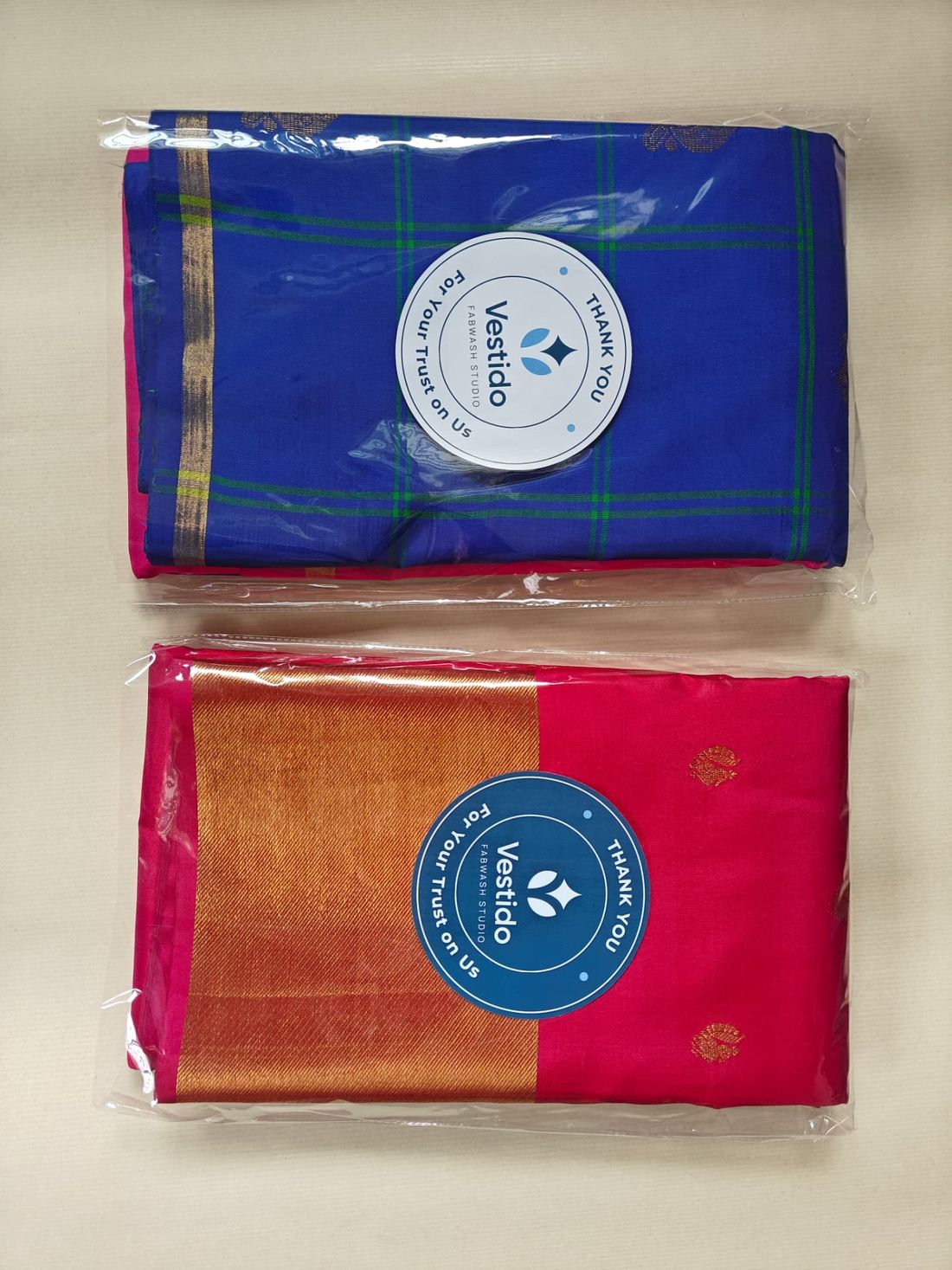 Blue checked and pink zari silk sarees roll polished at Vestido Fabwash Studio Bangalore
