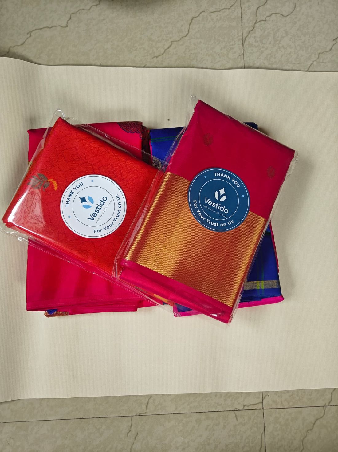 Brocade, blue and pink silk sarees after roll polishing with crisp drape restored